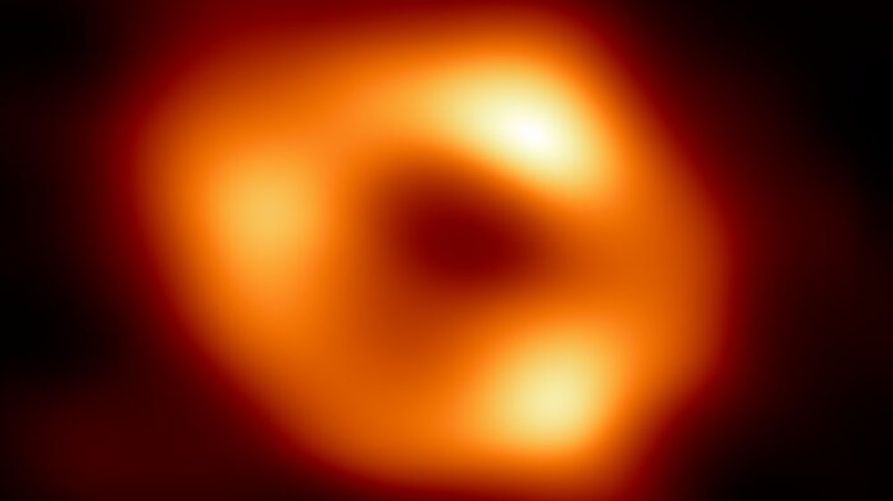 This is the first image of Sgr A*, the supermassive black hole at the centre of our galaxy. It’s the first direct visual evidence of the presence of this black hole. It was captured by the Event Horizon Telescope (EHT), an array which linked together eight existing radio observatories across the planet to form a single “Earth-sized” virtual telescope. The telescope is named after the event horizon, the boundary of the black hole beyond which no light can escape.   Although we cannot see the event horizon itself, because it cannot emit light, glowing gas orbiting around the black hole reveals a telltale signature: a dark central region (called a shadow) surrounded by a bright ring-like structure. The new view captures light bent by the powerful gravity of the black hole, which is four million times more massive than our Sun. The image of the Sgr A* black hole is an average of the different images the EHT Collaboration has extracted from its 2017 observations.  In addition to other facilities, the EHT network of radio observatories that made this image possible includes the Atacama Large Millimeter/submillimeter Array (ALMA) and the Atacama Pathfinder EXperiment (APEX) in the Atacama Desert in Chile, co-owned and co-operated by ESO is a partner on behalf of its member states in Europe.